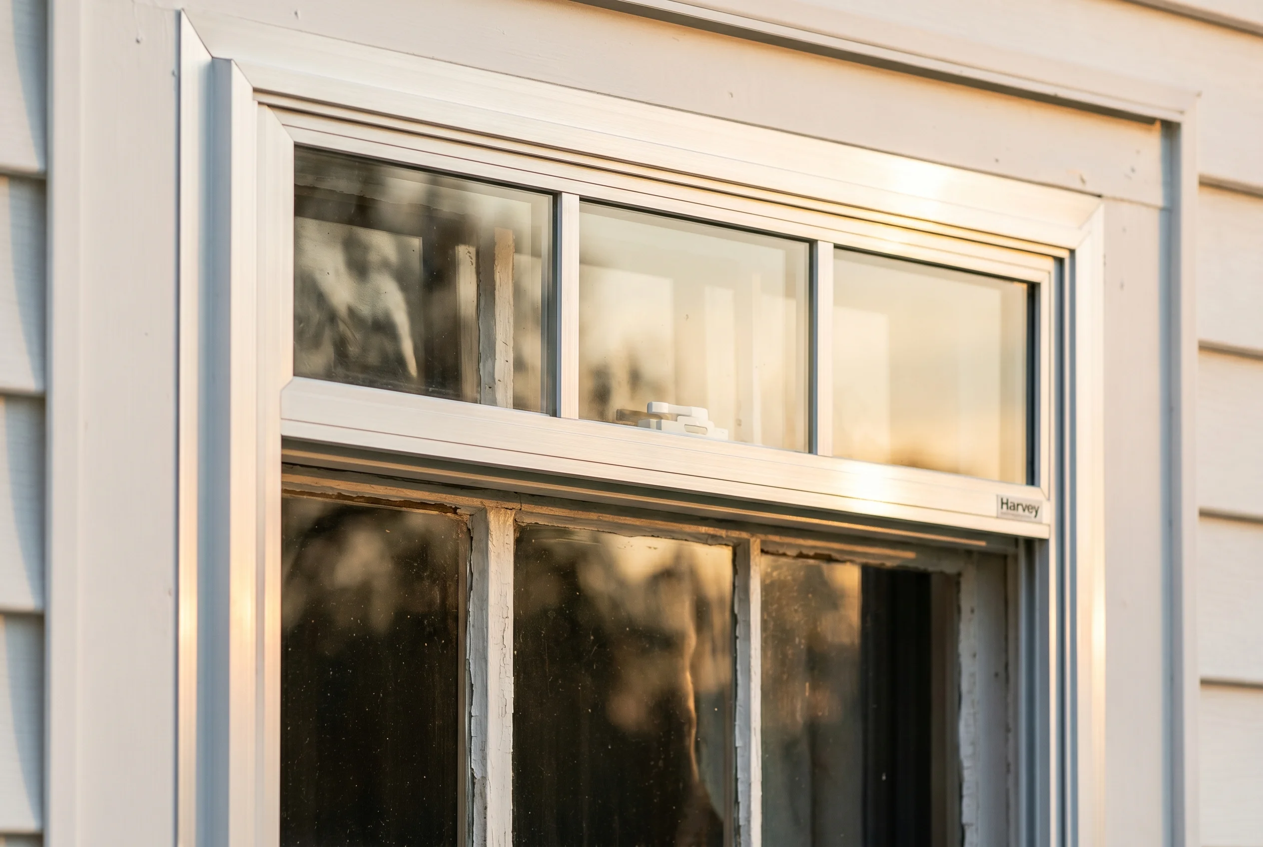 Brand-new Harvey aluminum storm sash combo installed over an existing historic primary window on a Louisburg restoration
