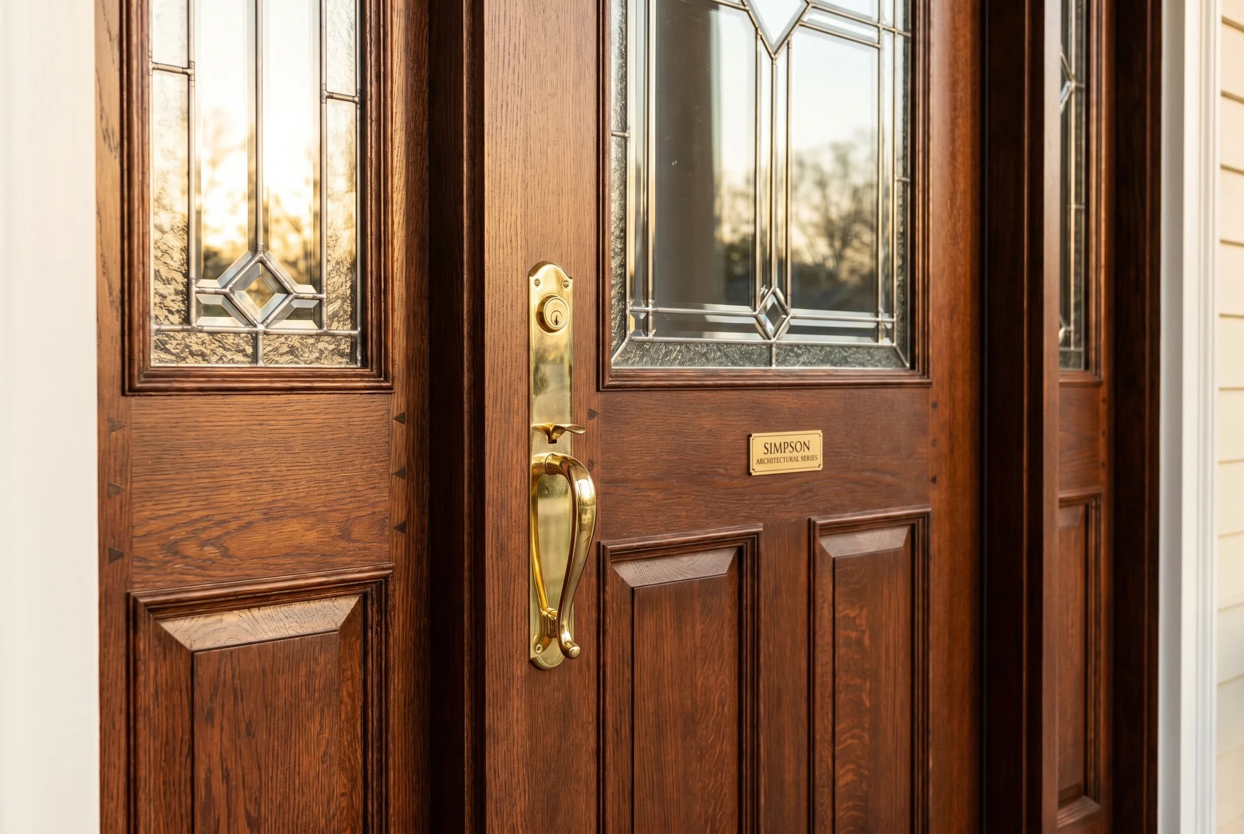 Brand-new Simpson Architectural Series restoration-grade wood door with historically accurate panel layout, leaded glass-light divisions, matching sidelights