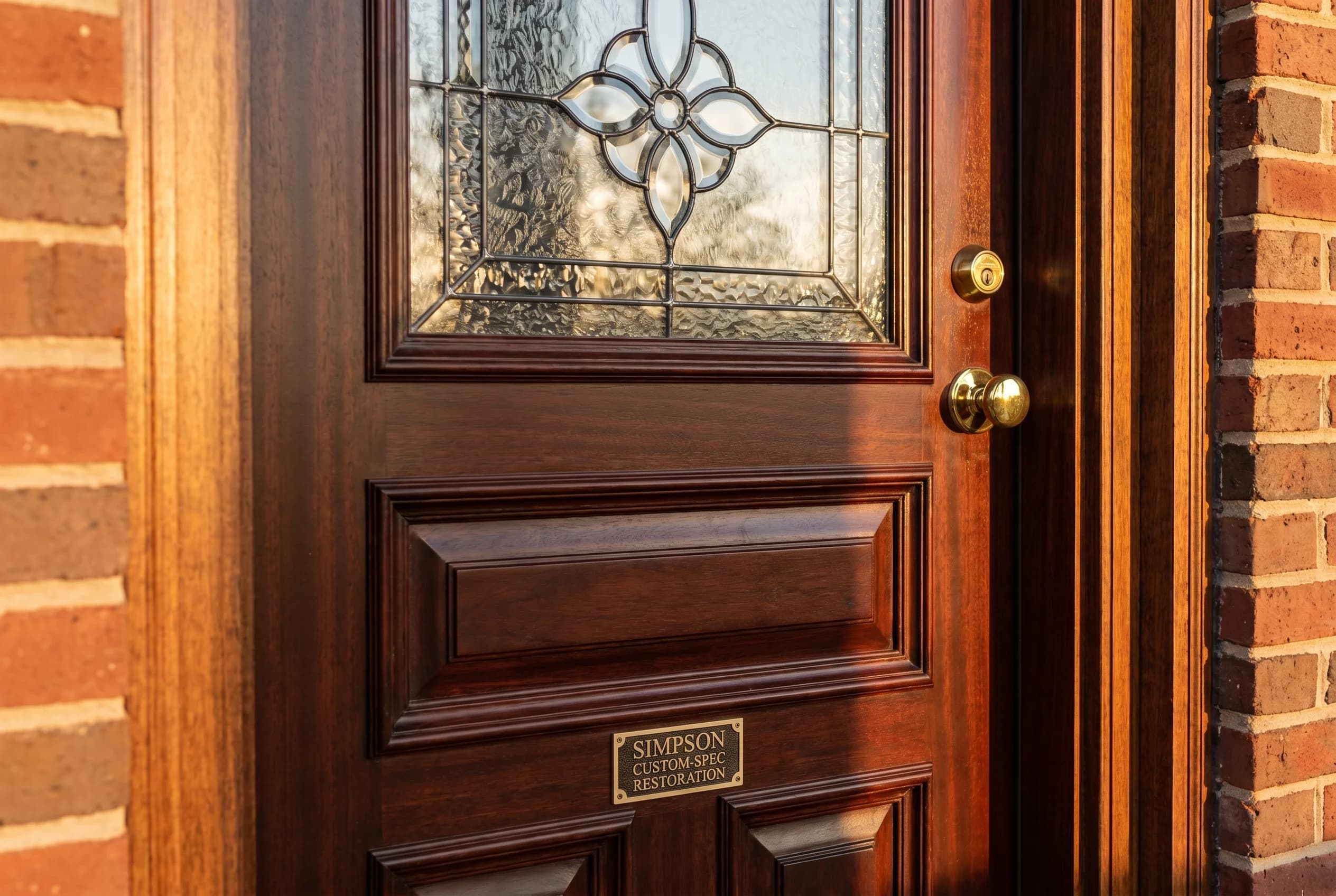 Brand-new Simpson Custom-Spec restoration entry door with premium panel configuration matching the home's architectural era, intricate leaded glass insert, period-authentic brass hardware