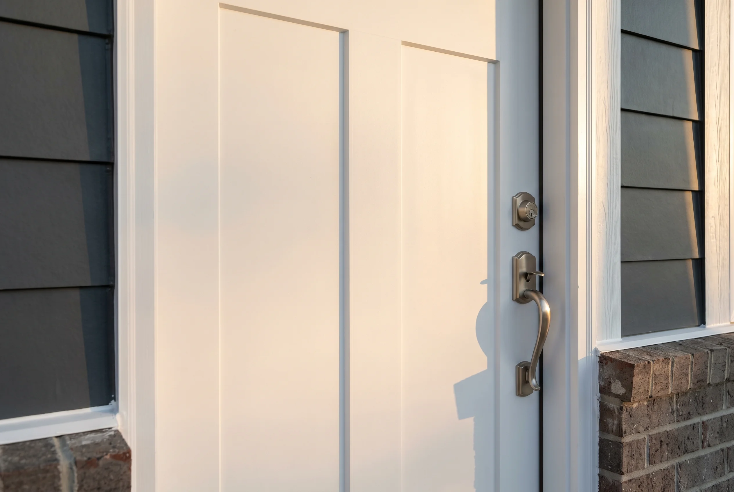 Brand-new Therma-Tru Smooth-Star smooth white painted fiberglass entry door with clean modern panel reveals, brushed nickel hardware